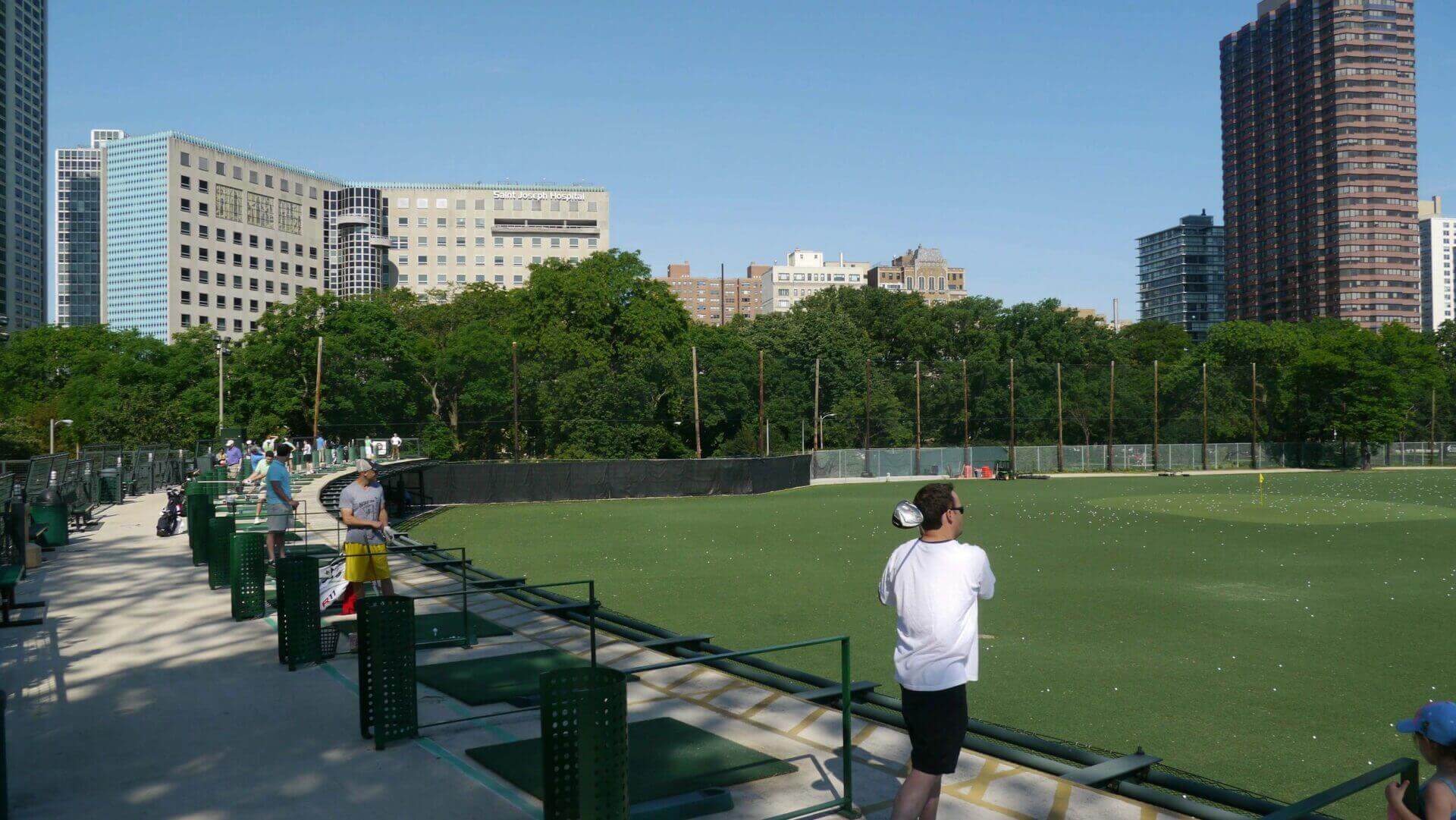 A man taking a picture of the grass on the field.