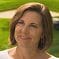 A woman with short hair is smiling for the camera.